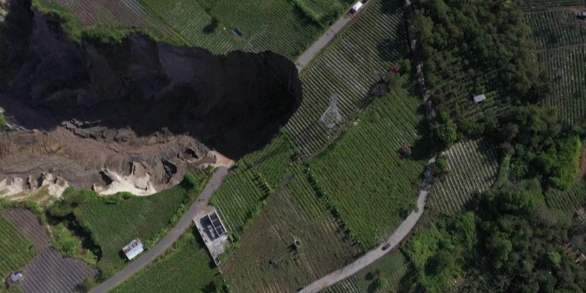 Roads and farmland swallowed with the appearance of a sinkhole in